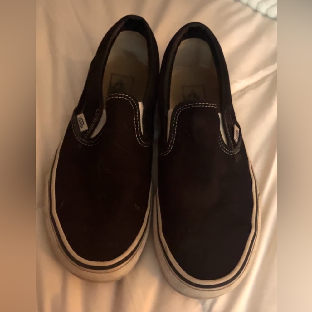 a pair of worn vans size 9